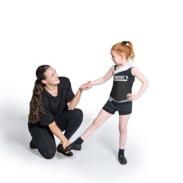 A student at Simone's School of Performing Arts receiving personalized instruction from a teacher, highlighting the benefits of dance, confidence-building, and supportive dance classes for kids.