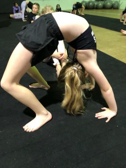 Student mastering acro dance techniques at Simone’s School of Performing Arts. Learn how acro is different from gymnastics and fosters strength, flexibility, and creativity in kids. Keywords: acro dance, gymnastics, strength, flexibility, creativity, kids dance classes near me.